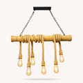 Industrial-style chandelier featuring a natural bamboo rod wrapped with thick rope, suspended from a black ceiling mount with two chains, holding five hanging Edison-style light bulbs.