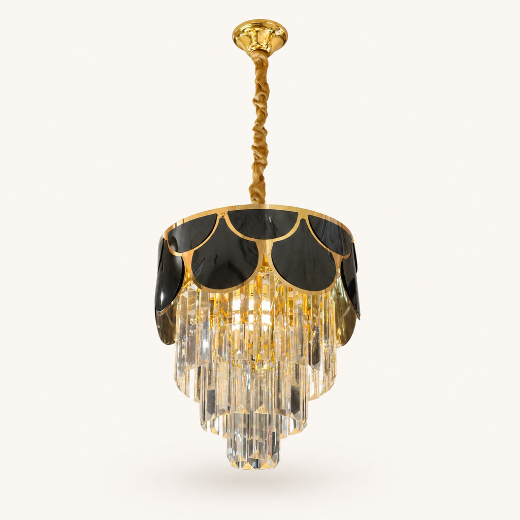 A gold and black chandelier pendant light with clear crystal drops, suspended from a twisted gold rod against a light beige background.