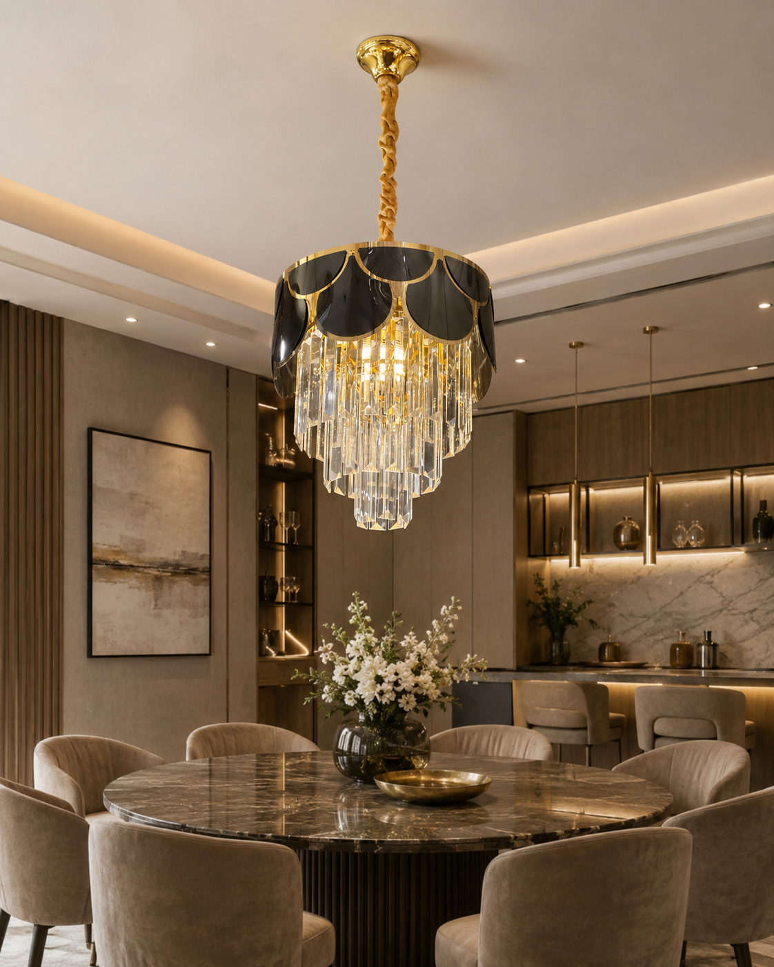 An elegant gold and black chandelier with cascading clear crystal prisms hanging over a round marble dining table in a modern, upscale dining room.