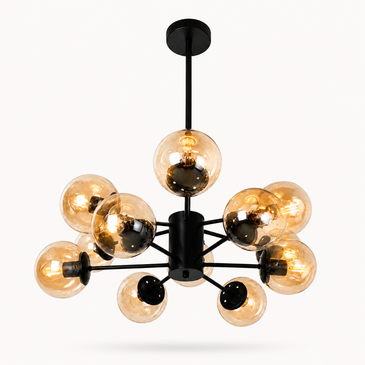 A modern multi-light chandelier with a matte black central hub and eight clear amber-tinted glass globes, shown against a plain light gray background.